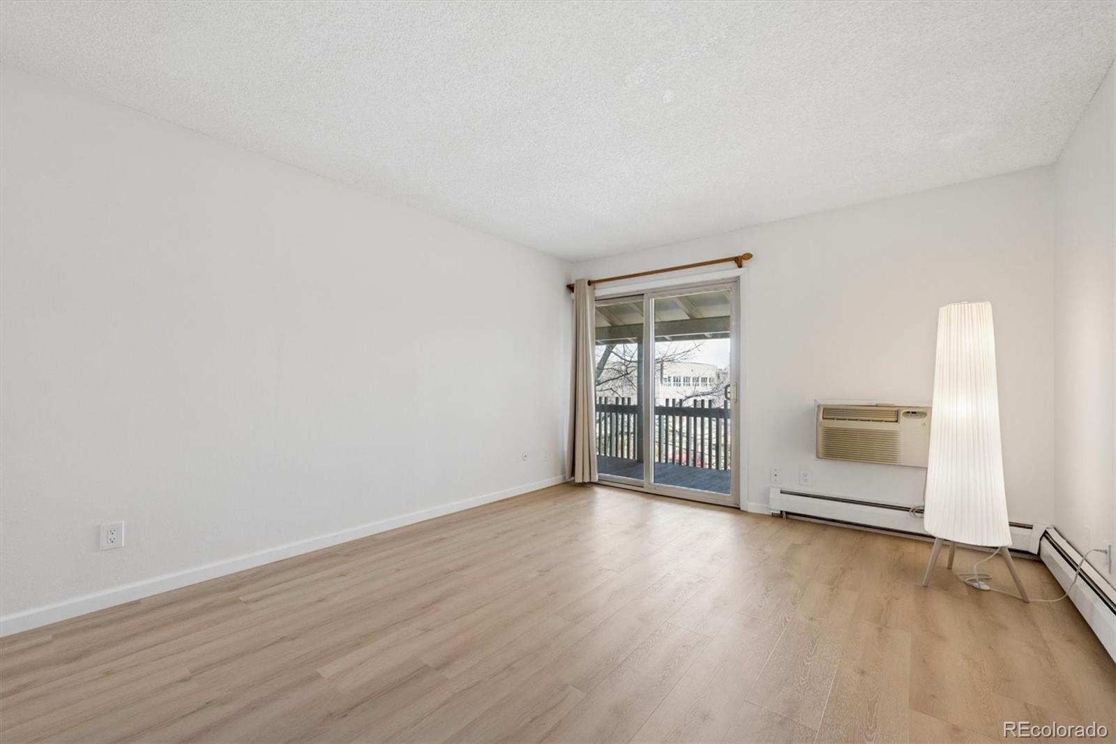 2707 Valmont Road, Unit 312D Boulder, CO 80304 - Photo 7 of 48 an empty room with wooden floor and windows