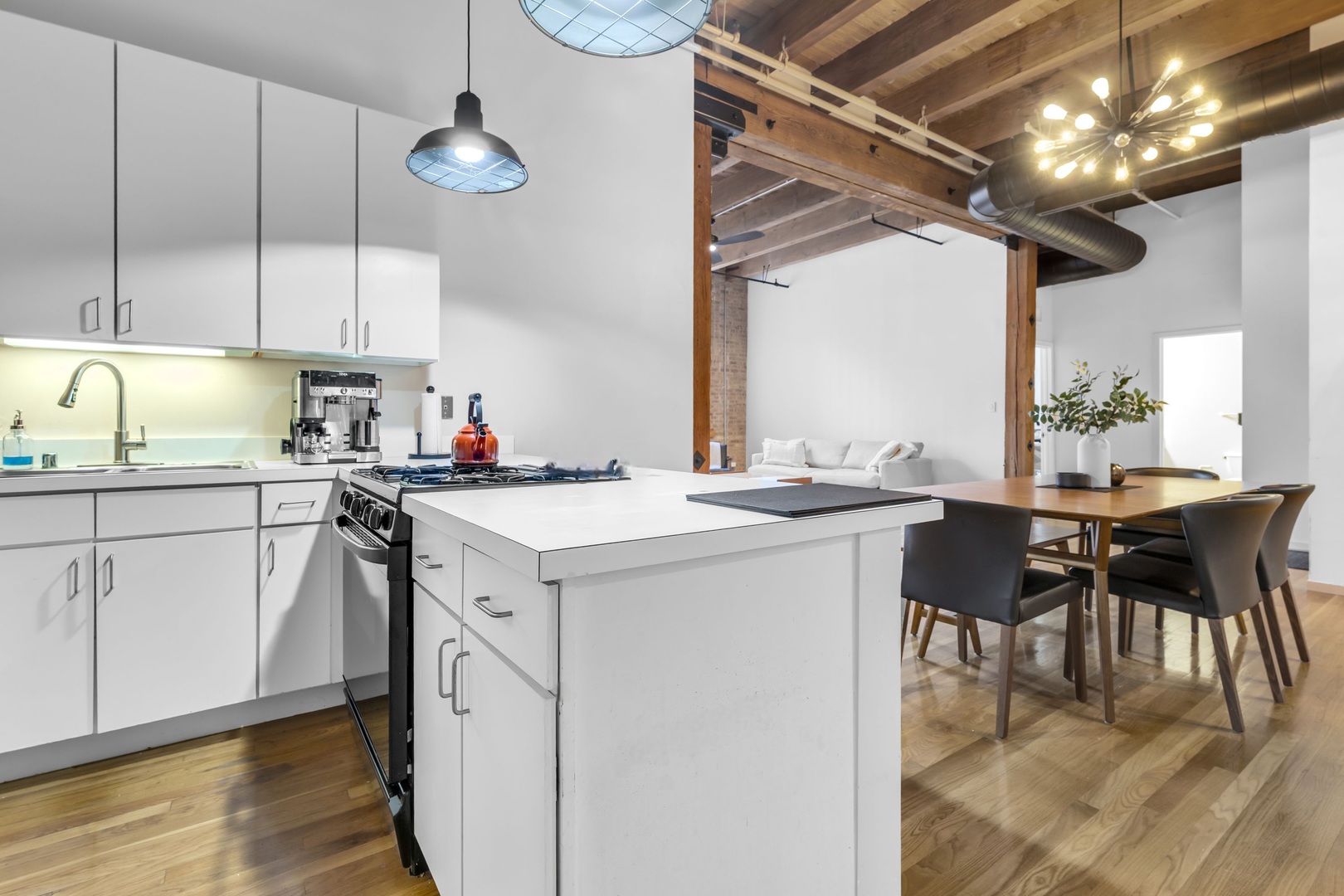 1727 South Indiana Avenue, Unit 320 Chicago, IL 60616 - Photo 13 of 28 a kitchen with a table chairs stove and cabinets