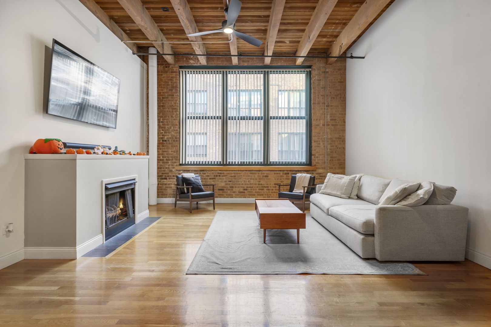 1727 South Indiana Avenue, Unit 320 Chicago, IL 60616 - Photo 4 of 28 a living room with furniture a fireplace and a large window