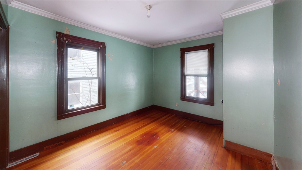 1403 Worcester Street Springfield, MA 01151 - Photo 11 of 23 an empty room with wooden floor and windows