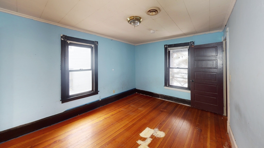 1403 Worcester Street Springfield, MA 01151 - Photo 14 of 23 an empty room with wooden floor and windows