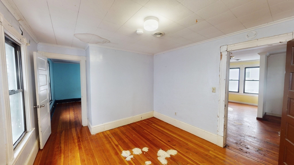 1403 Worcester Street Springfield, MA 01151 - Photo 16 of 23 wooden floor in an empty room with a window