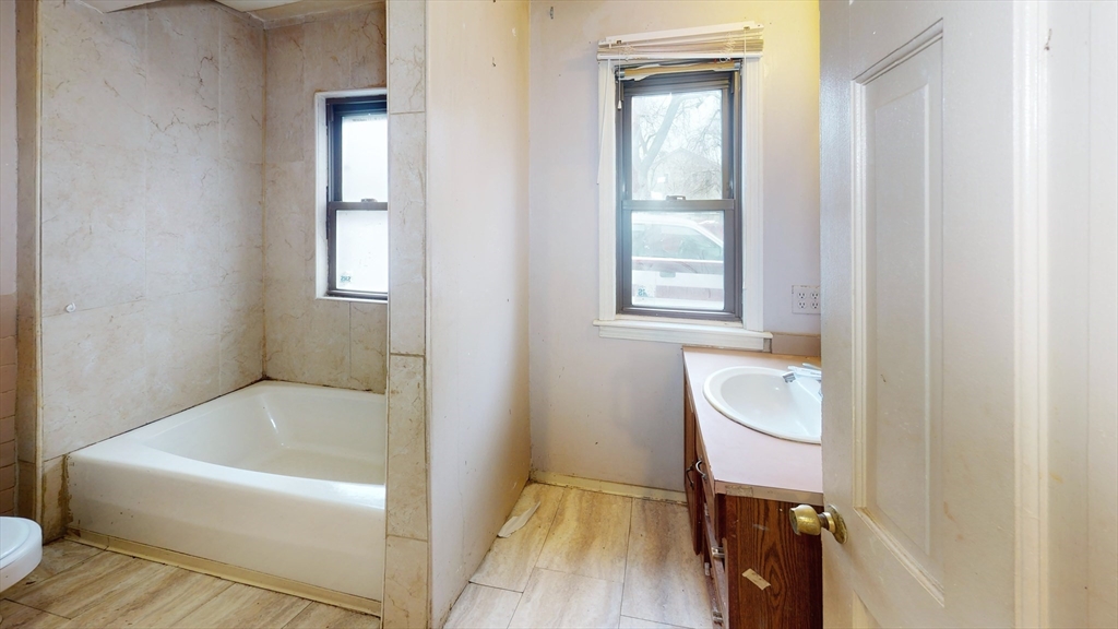 1403 Worcester Street Springfield, MA 01151 - Photo 18 of 23 a bathroom with a bathtub sink and window