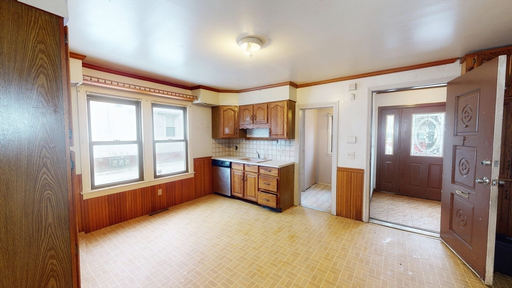 1403 Worcester Street Springfield, MA 01151 - Photo 4 of 23 a view of a kitchen with a refrigerator cabinet a sink and a window