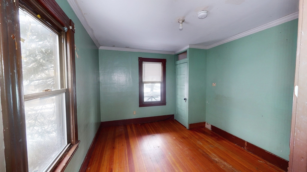 1403 Worcester Street Springfield, MA 01151 - Photo 10 of 23 a view of an empty room with wooden floor and a window