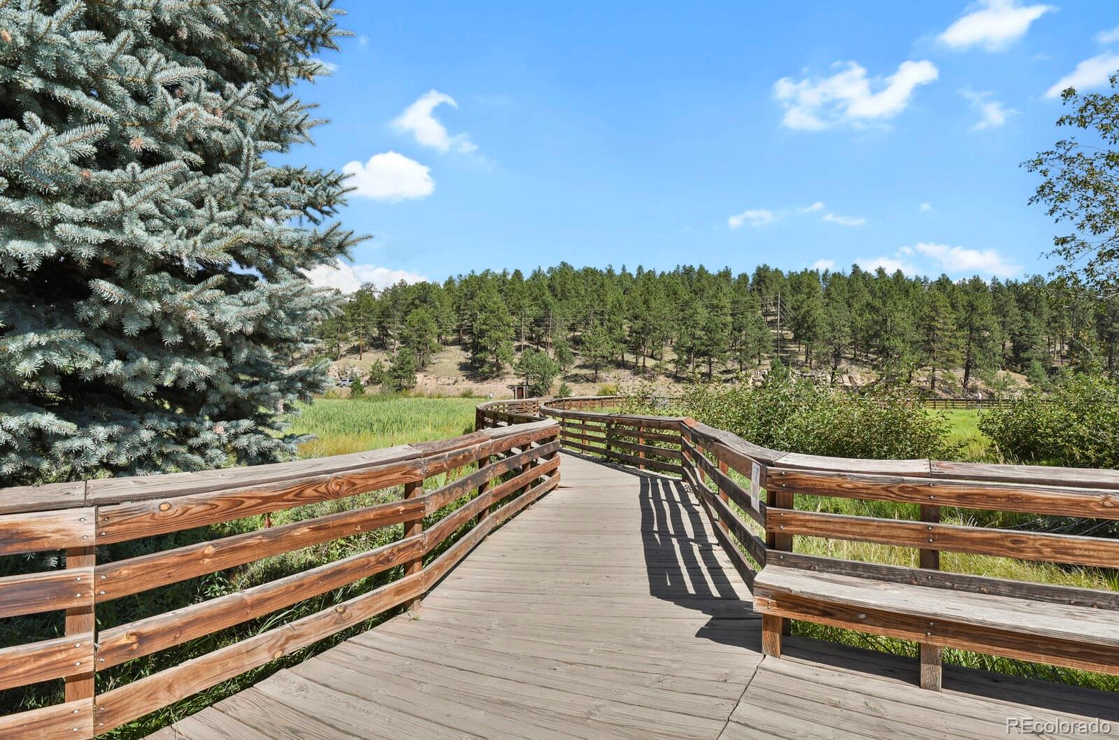 281 Kings Road Evergreen, CO 80439 - Photo 15 of 17 a view of a balcony with wooden floor and fence