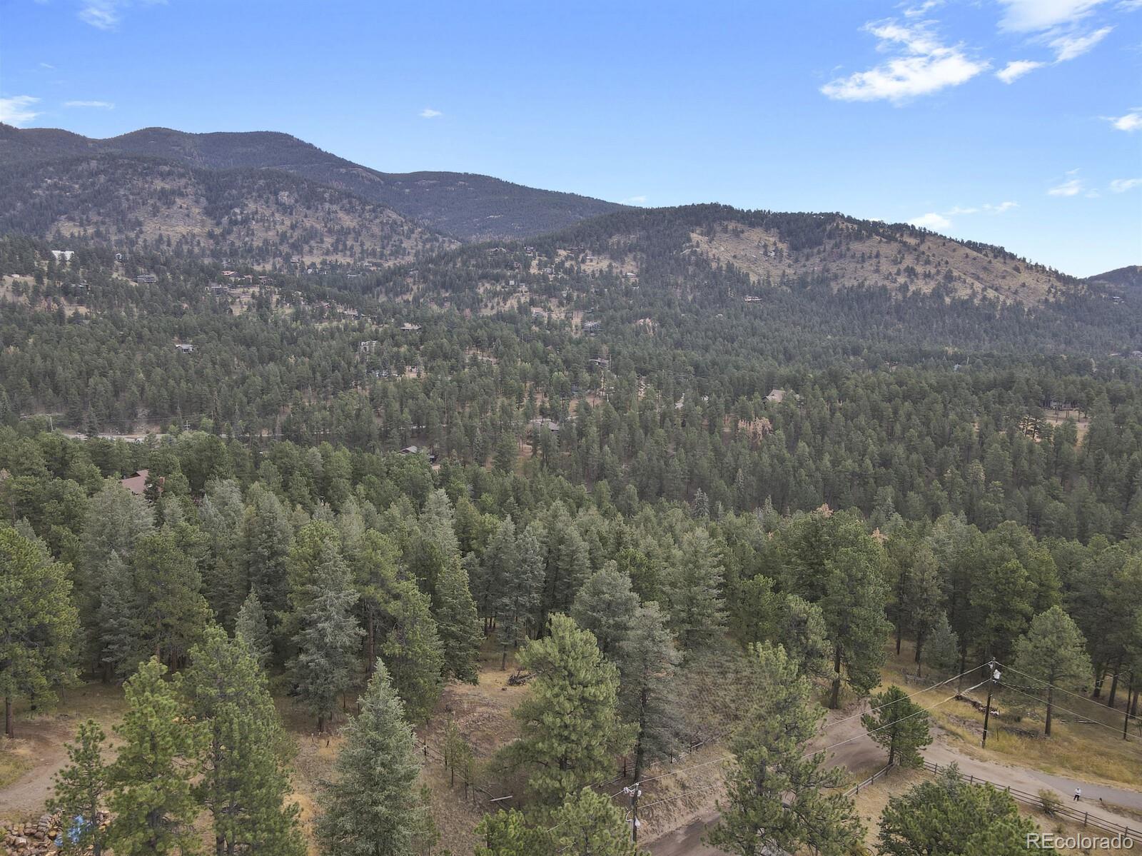 281 Kings Road Evergreen, CO 80439 - Photo 3 of 17 a view of a hillside and a mountain