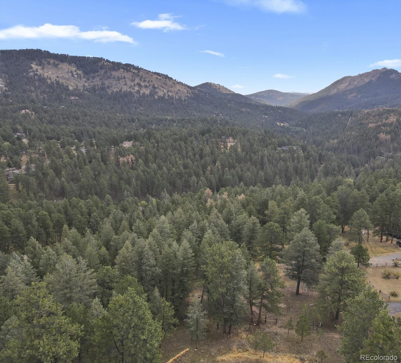 281 Kings Road Evergreen, CO 80439 - Photo 5 of 17 a view of a mountain range in a cloudy sky