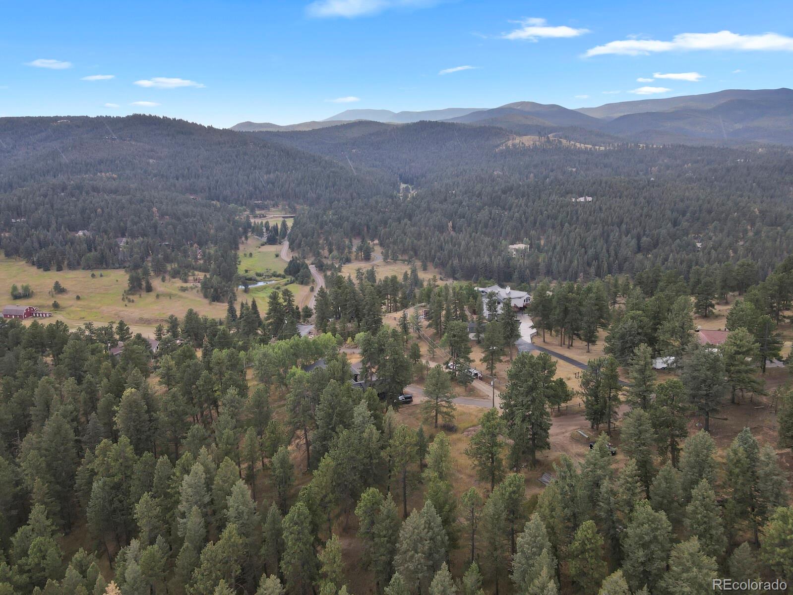 281 Kings Road Evergreen, CO 80439 - Photo 8 of 17 a view of a town with mountains in the background