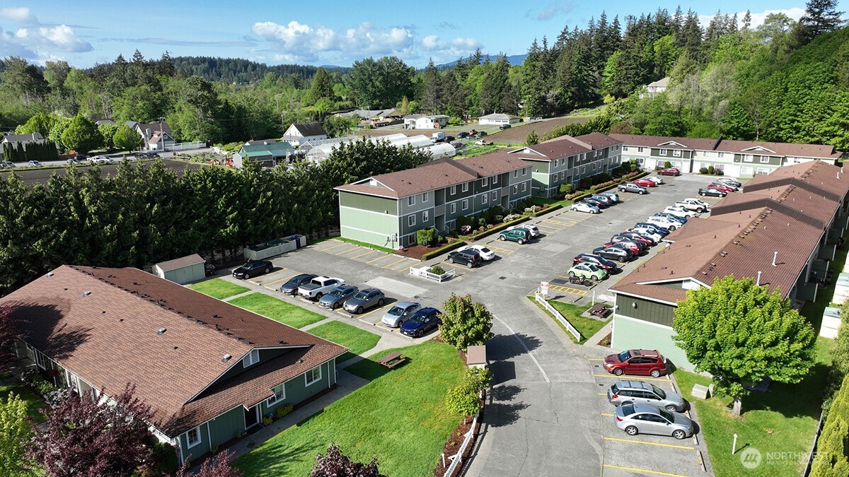 an aerial view of multiple houses with yard