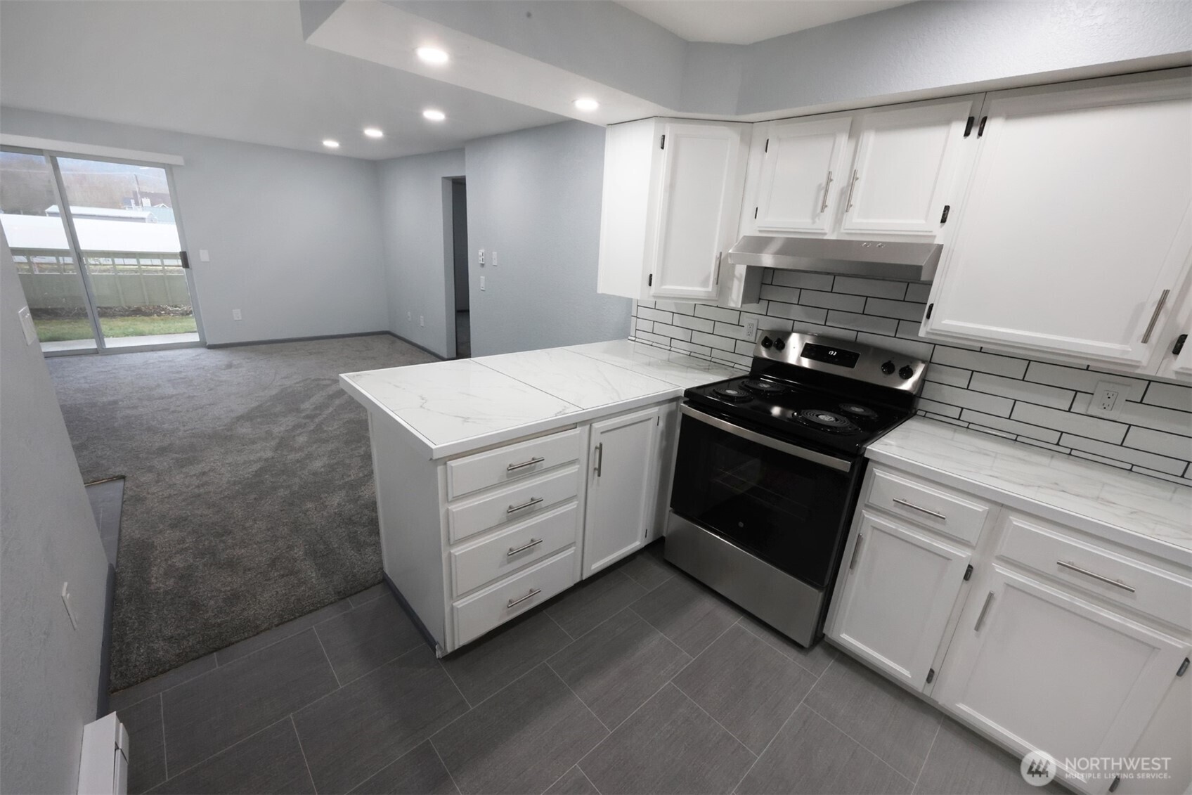 820 32nd Street Bellingham, WA 98225 - Photo 14 of 39 a kitchen with a stove white cabinets and a refrigerator