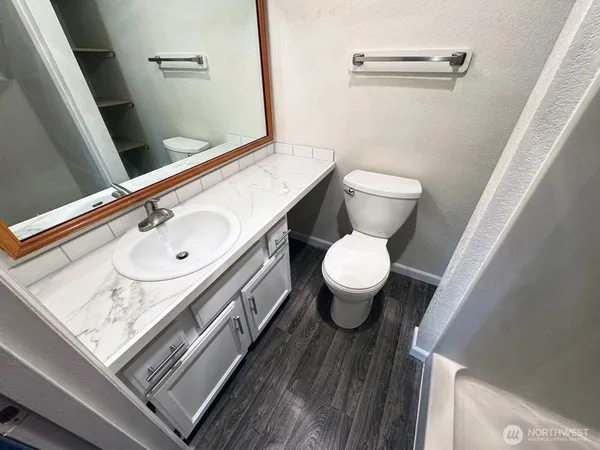 a bathroom with a sink toilet and shower