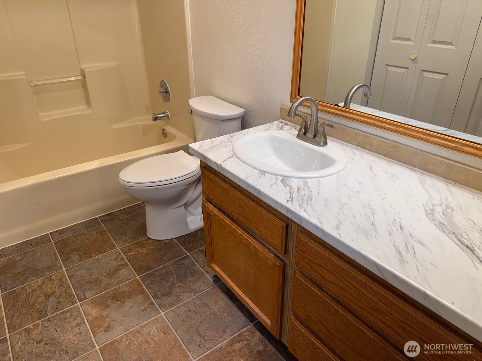 820 32nd Street Bellingham, WA 98225 - Photo 24 of 39 a bathroom with a granite countertop sink toilet and shower