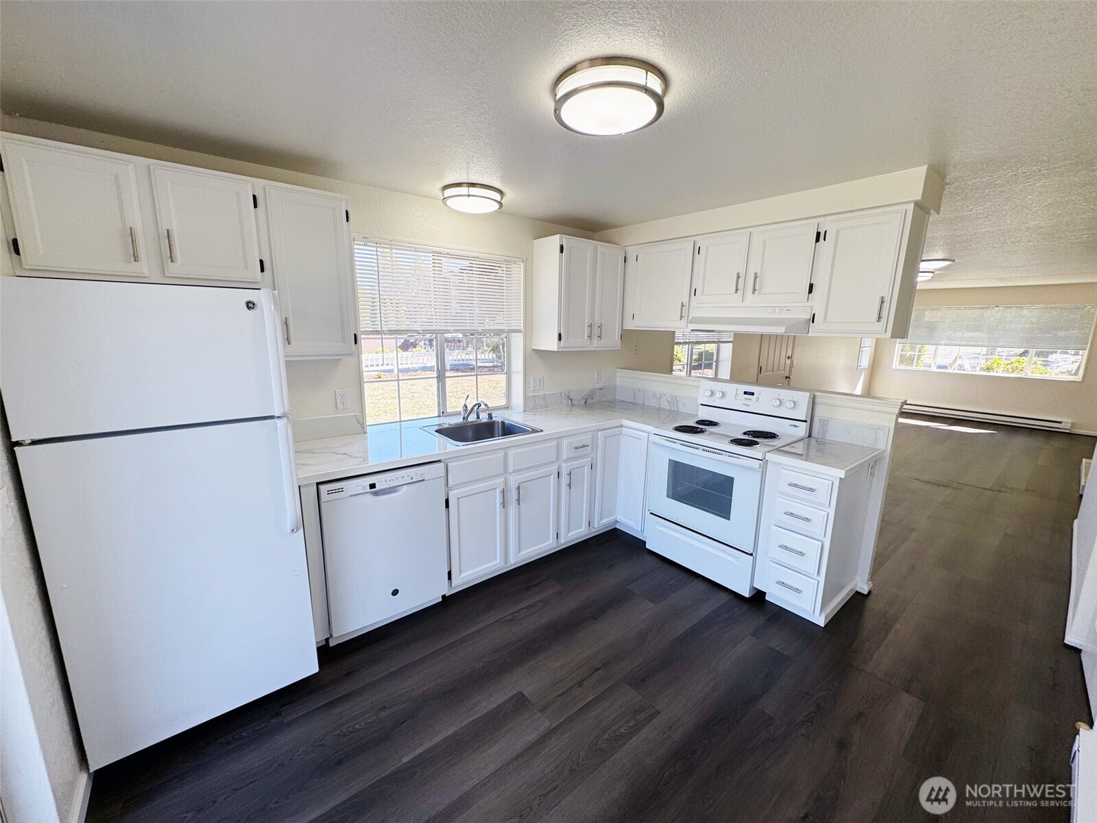 820 32nd Street Bellingham, WA 98225 - Photo 27 of 39 a kitchen with cabinets a sink and white appliances