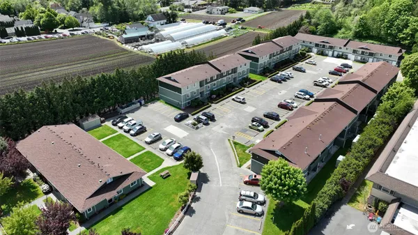 an aerial view of a house with a yard basket ball court and outdoor seating