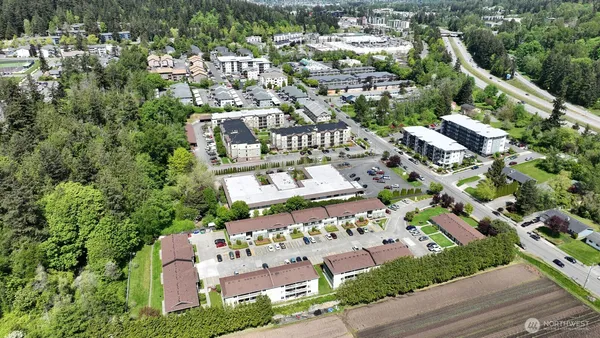 a front view of a house with cars parked