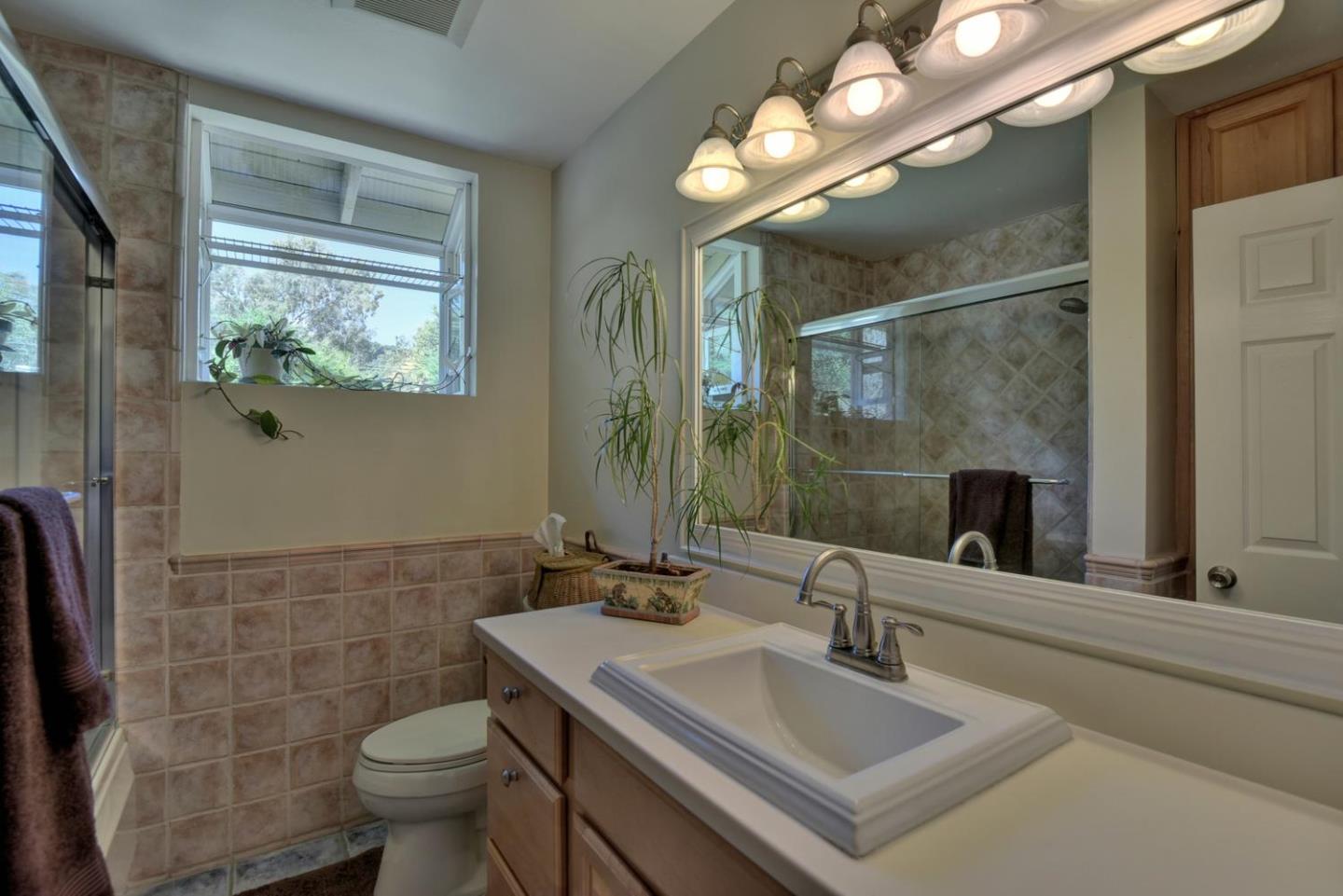 1175 Llagas Road Morgan Hill, CA 95037 - Photo 21 of 37 a bathroom with a sink toilet and mirror