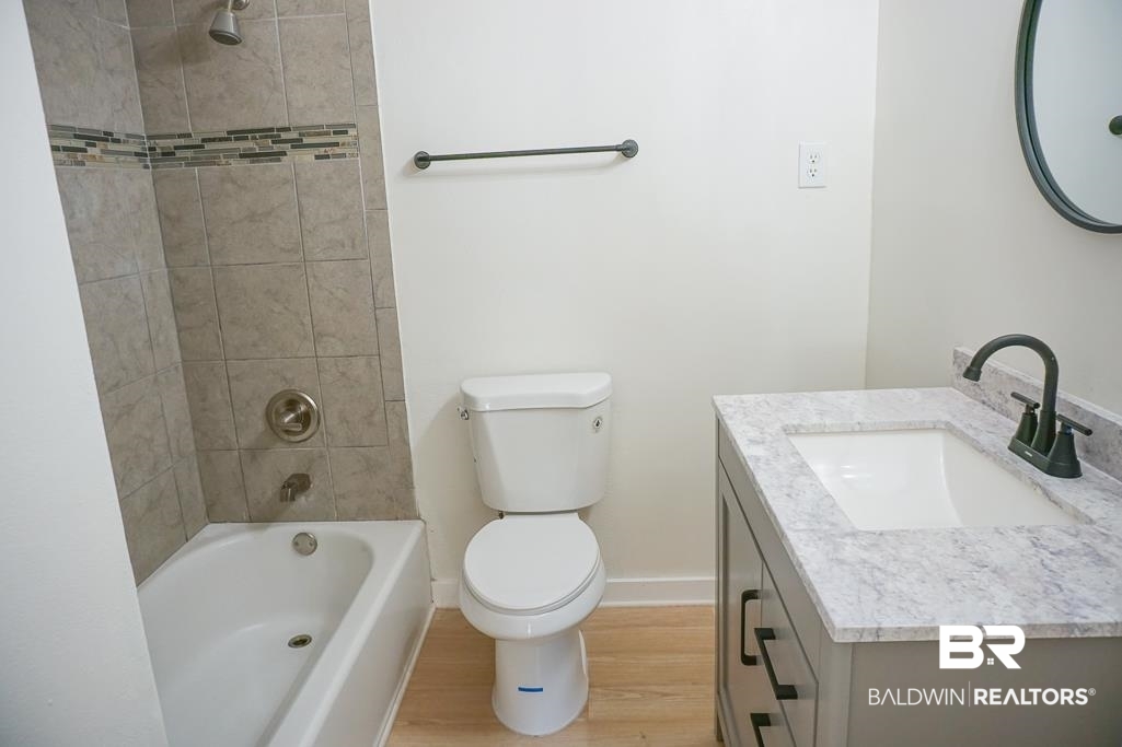 4667 Cottonwood Drive Mobile, AL 36608 - Photo 20 of 21 Full bathroom with hardwood / wood-style flooring, vanity, toilet, and tiled shower / bath combo