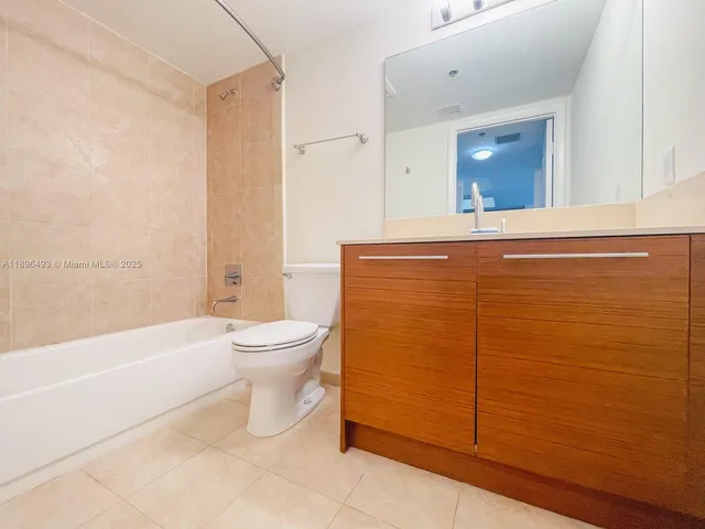 a bathroom with a toilet a sink and bathtub