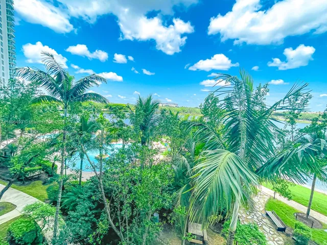 a living room with furniture and large windows