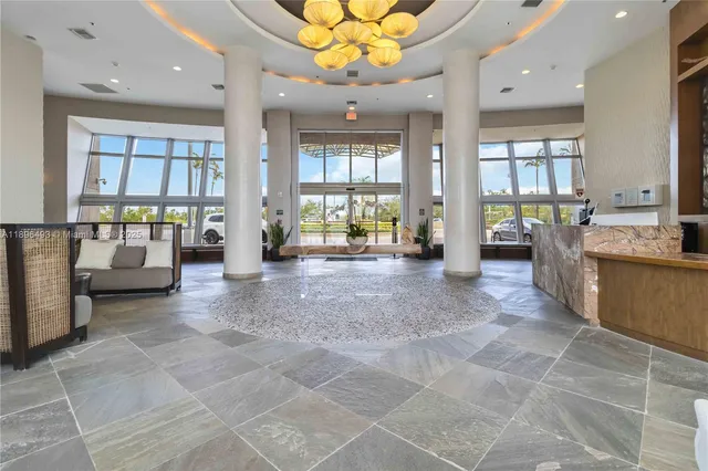 a room with lots of furniture and a chandelier