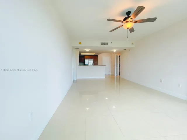a view of a room with a ceiling fan