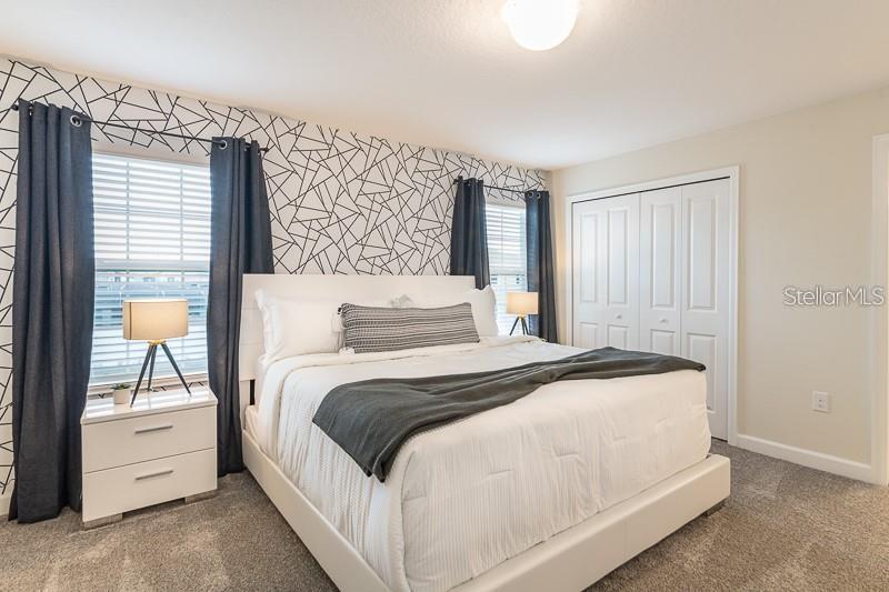 5025 Windermere Avenue Kissimmee, FL 34746 - Photo 11 of 33 a bedroom with a bed and a night stand