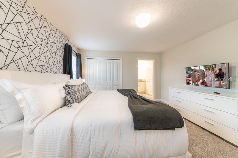 5025 Windermere Avenue Kissimmee, FL 34746 - Photo 12 of 33 a bedroom with a large bed and a window