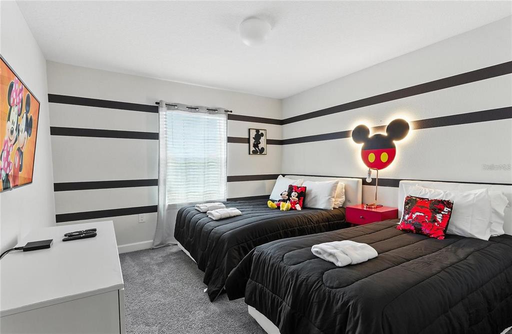 5025 Windermere Avenue Kissimmee, FL 34746 - Photo 16 of 33 a bedroom with bed and furniture