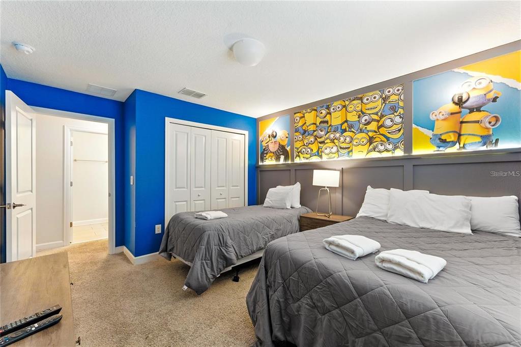 5025 Windermere Avenue Kissimmee, FL 34746 - Photo 23 of 33 a bedroom with two beds and painting on the wall