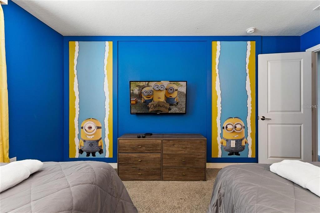 5025 Windermere Avenue Kissimmee, FL 34746 - Photo 24 of 33 a bedroom with a bed and a flat screen tv