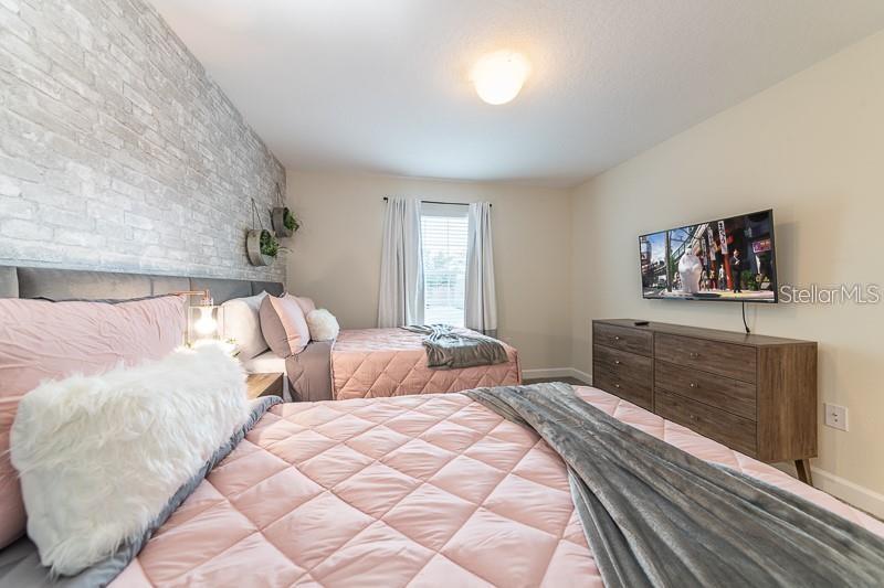 5025 Windermere Avenue Kissimmee, FL 34746 - Photo 25 of 33 a bedroom with a bed and a flat screen tv