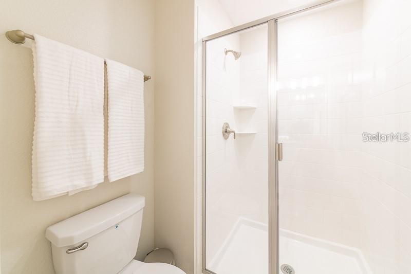 5025 Windermere Avenue Kissimmee, FL 34746 - Photo 27 of 33 a bathroom with a shower and a toilet