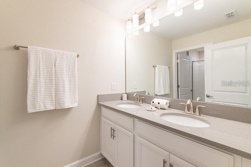 5025 Windermere Avenue Kissimmee, FL 34746 - Photo 28 of 33 a bathroom with a sink double vanity and a mirror