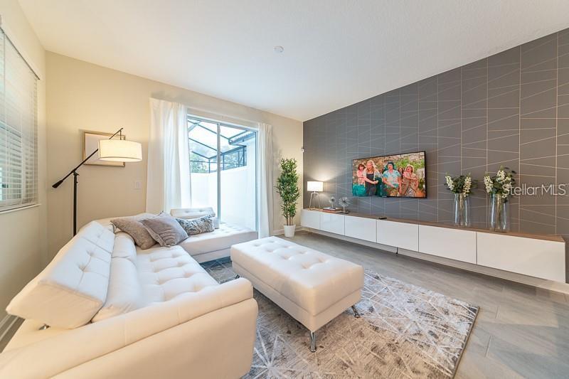 5025 Windermere Avenue Kissimmee, FL 34746 - Photo 6 of 33 a living room with furniture and a flat screen tv