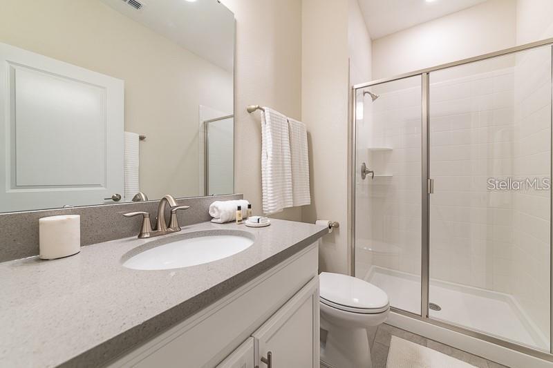 5025 Windermere Avenue Kissimmee, FL 34746 - Photo 8 of 33 a bathroom with a granite countertop sink toilet and shower