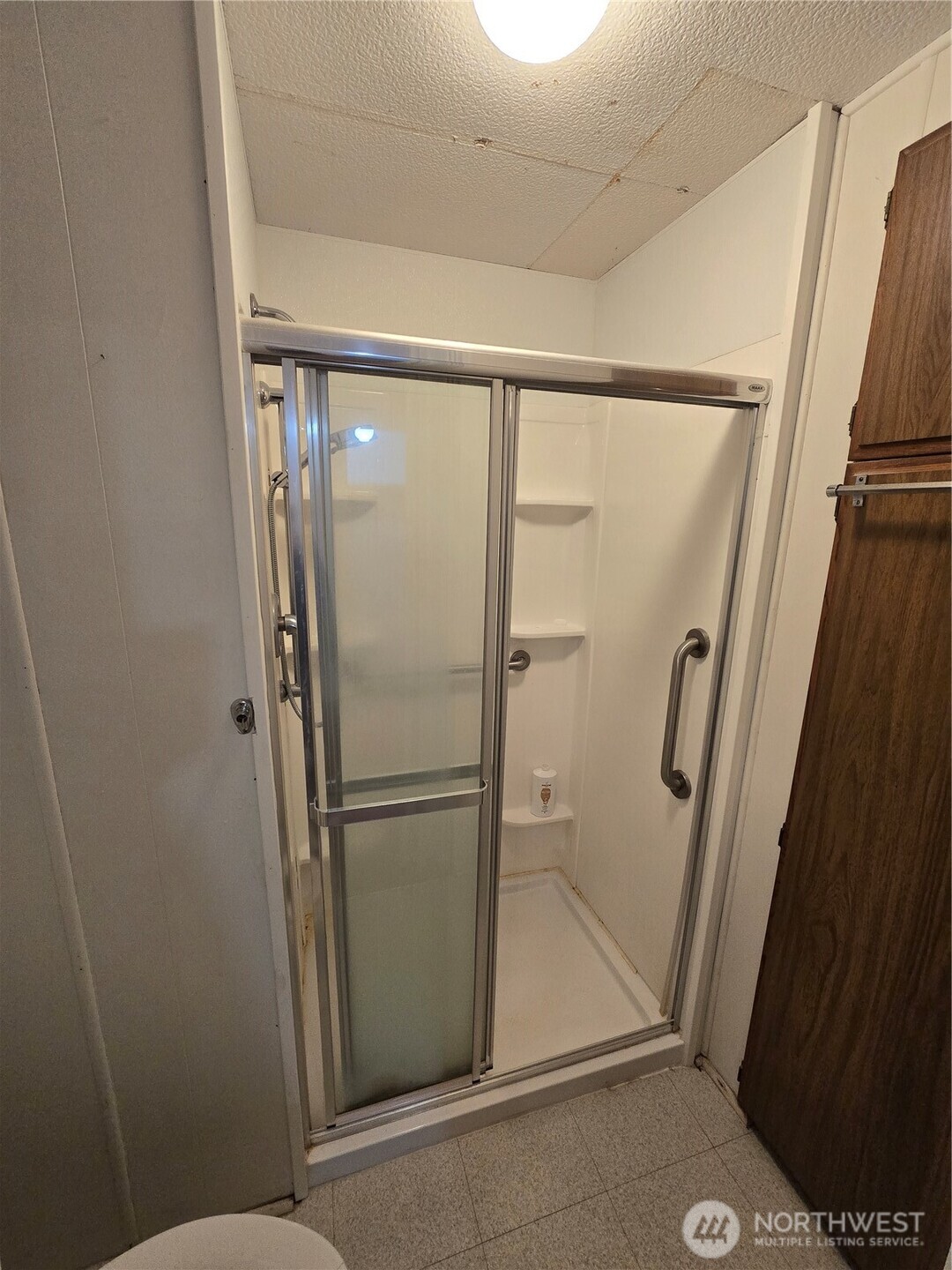 2302 R Street Southeast, Unit 115 Auburn, WA 98002 - Photo 16 of 33 a bathroom with a glass door shower and a sink