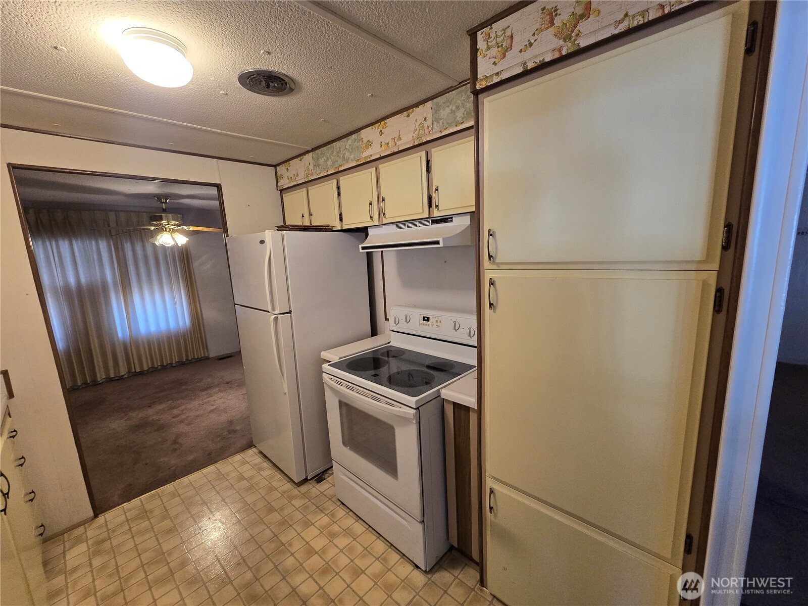 2302 R Street Southeast, Unit 115 Auburn, WA 98002 - Photo 10 of 33 a kitchen with a refrigerator sink and stove
