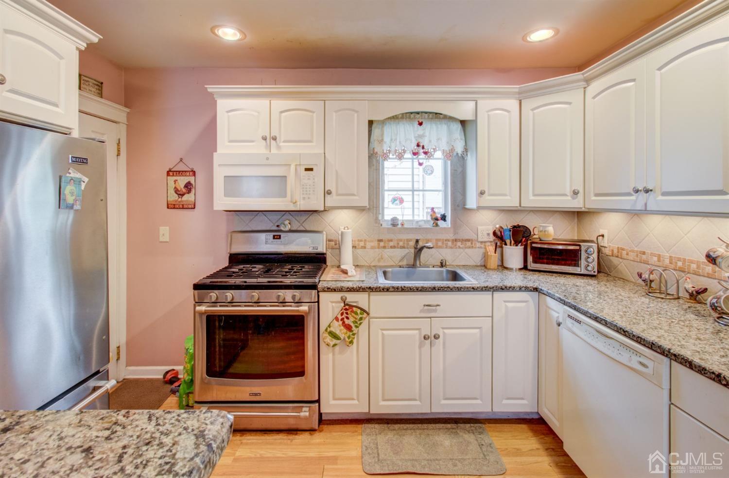 3 Division Street Metuchen, NJ 08840 - Photo 11 of 20 a kitchen with white cabinets sink and stainless steel appliances