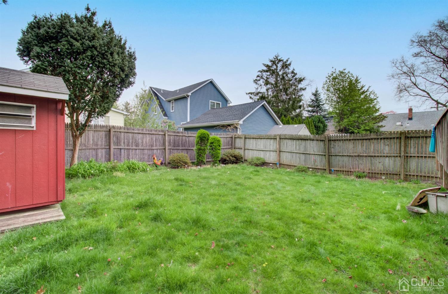 3 Division Street Metuchen, NJ 08840 - Photo 17 of 20 a view of a backyard with a garden and trees