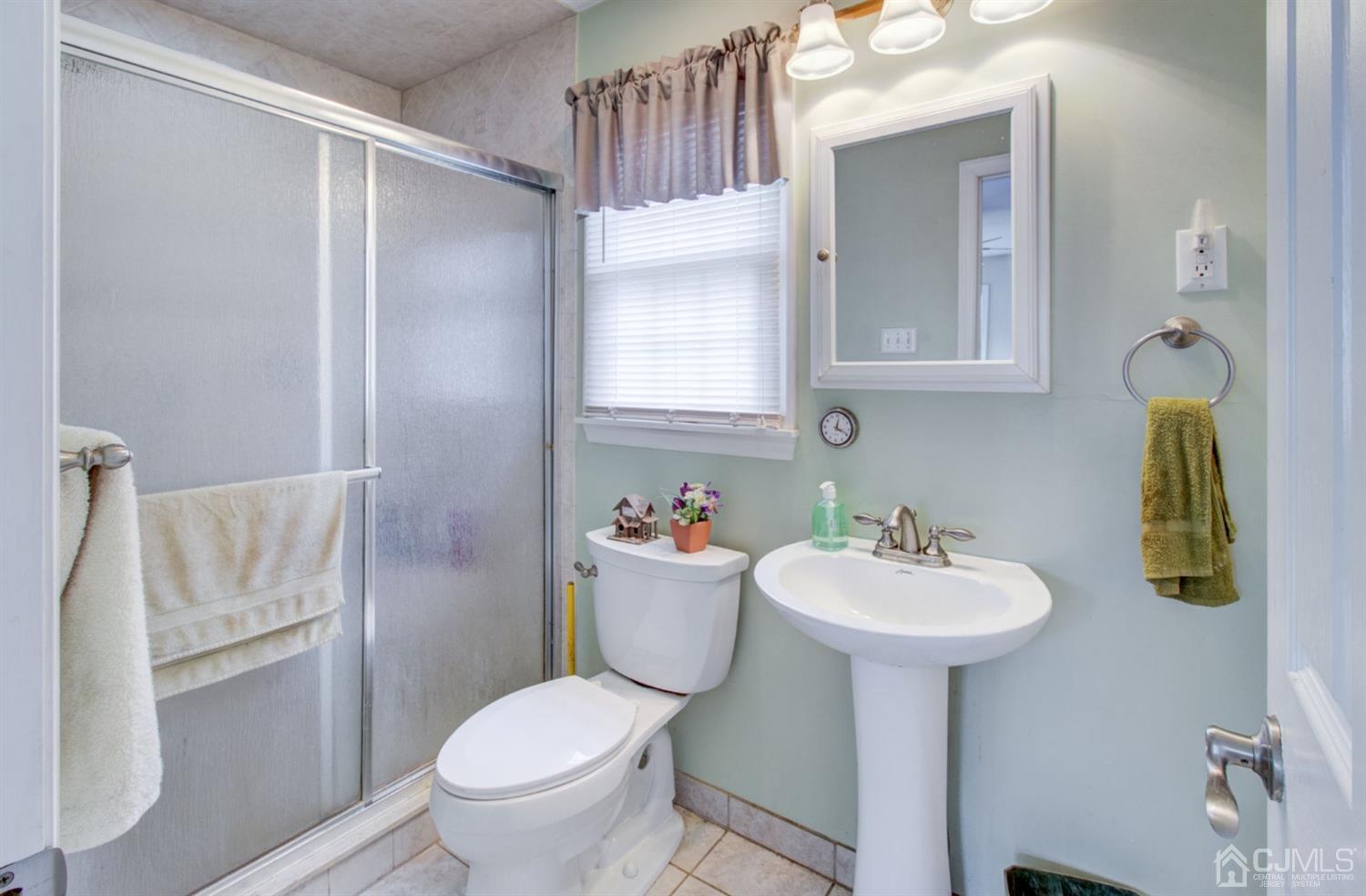 3 Division Street Metuchen, NJ 08840 - Photo 5 of 20 a bathroom with a sink toilet and mirror
