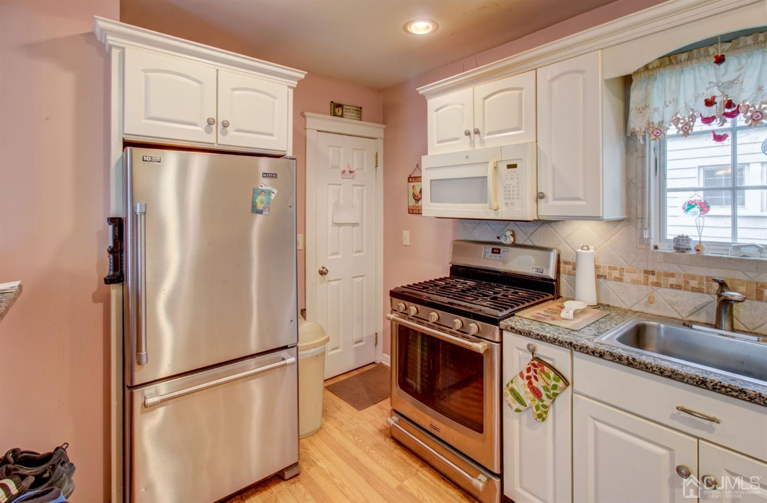 3 Division Street Metuchen, NJ 08840 - Photo 9 of 20 a kitchen with granite countertop a refrigerator stove and sink