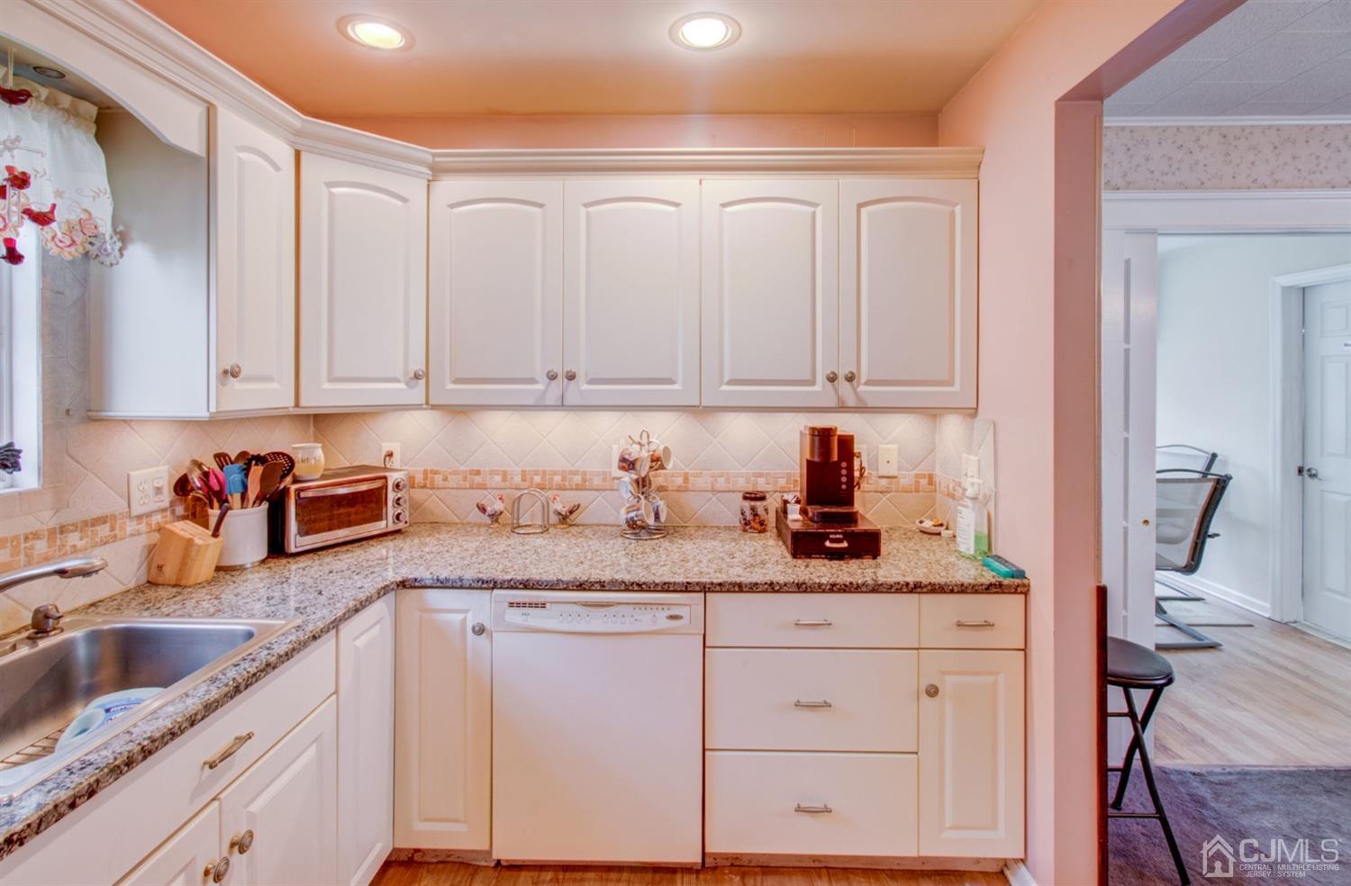 3 Division Street Metuchen, NJ 08840 - Photo 10 of 20 a kitchen with granite countertop white cabinets and sink