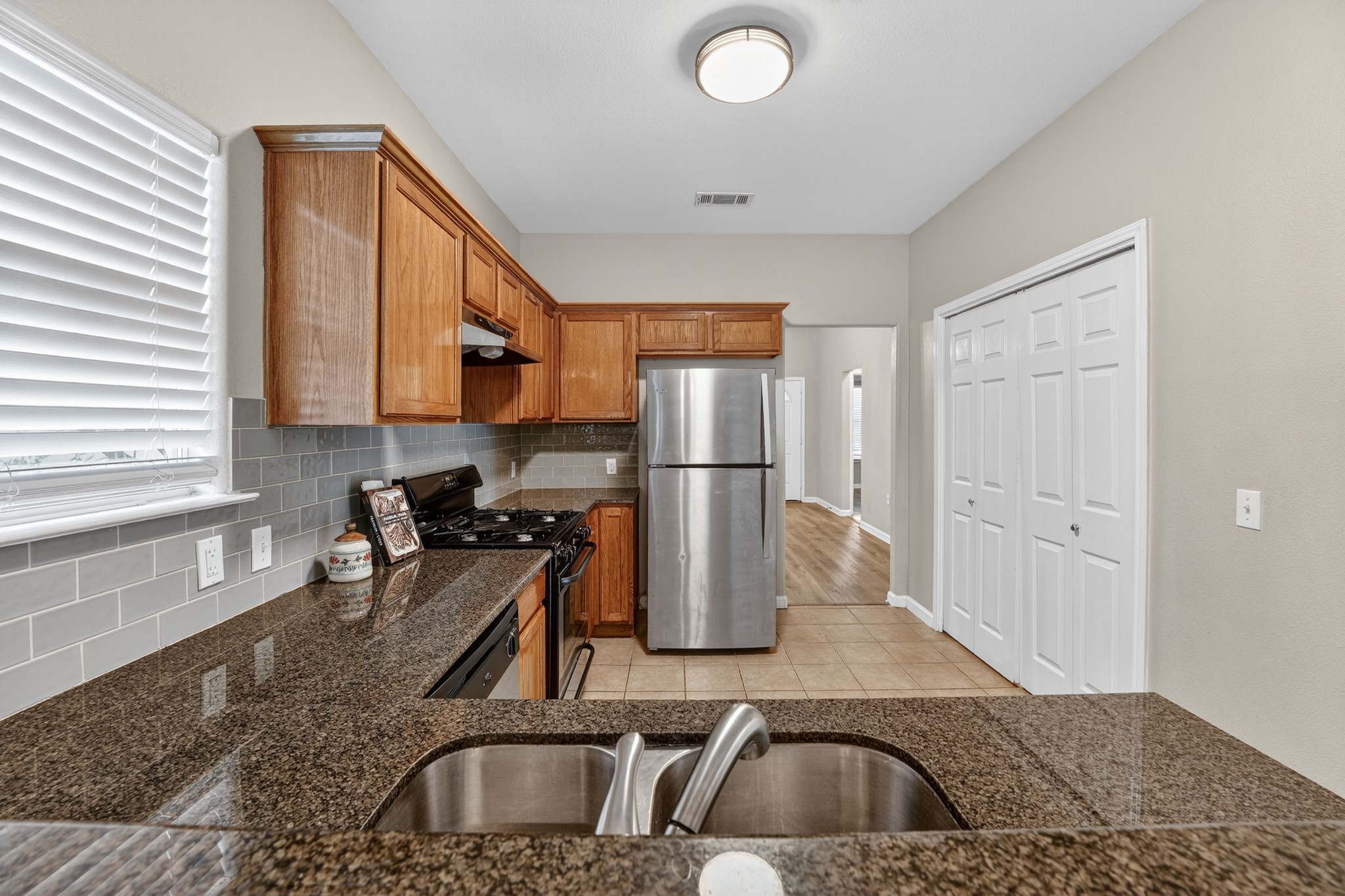 5625 Signal Point Austin, TX 78724 - Photo 12 of 33 A well-appointed kitchen showcases granite counters, wood cabinetry, and stainless steel appliances.