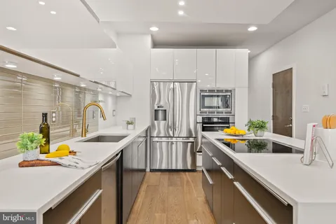 a kitchen with stainless steel appliances a sink stove and refrigerator