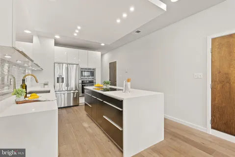 a kitchen with a sink a stove and refrigerator