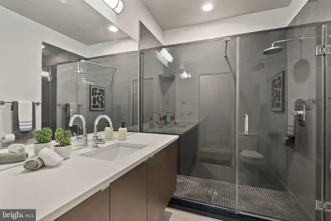 a bathroom with a shower sink vanity and mirror
