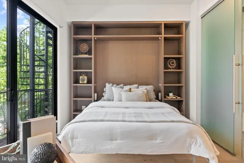 a bedroom with a large bed and a window