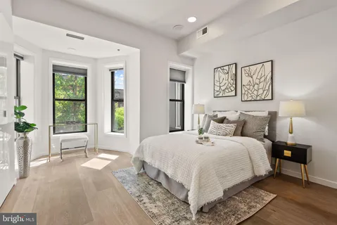 a bedroom with a large bed and a large window