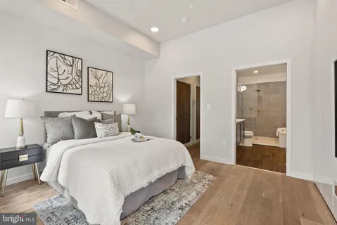 a bedroom with a bed and a large mirror